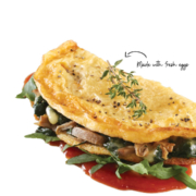 Omelette filled with mushrooms and topped with herbs.