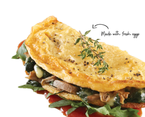 Omelette filled with mushrooms and topped with herbs.