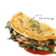 Omelette filled with mushrooms and topped with herbs.