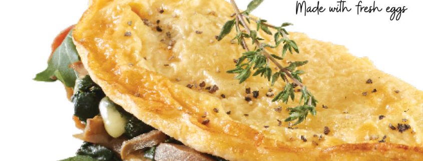 Omelette filled with mushrooms and topped with herbs.
