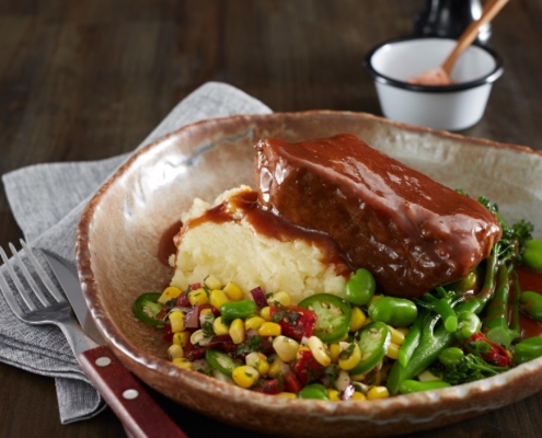 Beef Brisket plated with mashed potato and greens