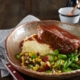 Beef Brisket plated with mashed potato and greens